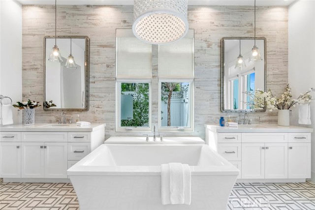 Primary Bathroom featuring soaking tub and double sinks