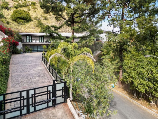 1293 Monte Cielo Drive Beverly Hills, California Nestled behind secure gates in Beverly Hills, this custom Built contemporary masterpiece unveils breathtaking canyon views and city lights, offering an unparalleled living experience. Upon entry, you are greeted by the allure of gorgeous granite & marble surfaces, accentuated by the warmth of natural woods and custom cabinetry. The architectural masterpiece blends indoor and outdoor living, with floor-to-ceiling glass doors that open up to wraparound outdoor spaces and leading you to a spacious Infinity edge pool, inviting spa, & cozy fireplace, creating an oasis of serenity & relaxation. From its foundation to its framework Built in 2012, this home is a fortress of quality craftsmanship. It's constructed to withstand the test of time, offering a sense of security and peace of mind that only a solidly built home can provide. The Home features 6,875 square feet of luxury. For the culinary enthusiast, the chef's kitchen is a culinary haven, complete with top-of-the-line appliances. Two master suites provide the ultimate in comfort and privacy. Ascending to the upper level, you'll discover the luxurious master suite, featuring vaulted ceilings and rich hardwood floors. The suite extends to a wraparound terrace with a cozy fireplace, offering a private oasis overlooking the pool area. The master bathroom is a spa-like retreat, adorned with marble surfaces, a spacious shower, dual sinks, and a spa tub. Additional accommodations on the main level include a second master suite with its own terrace, as well as two more well-appointed bedroom suites, ensuring comfort and privacy for all residents or guests. Car enthusiasts will be thrilled by the presence of an expansive 4-car garage. This showcase garage is more than just a space to park your vehicles; it's a collector's dream! For cinematic aficionados, the home theatre is a cinematic escape. Featuring state-of-the-art audio and visual technology, plush seating, it offers an immersive movie-watching experience that rivals the finest cinemas! This modern marvel also embraces advanced technology with solar panels, an alarm system, and smart home controls, all contributing to efficiency, security, and convenience. In summary, this Beverly Hills residence is a testament to modern luxury living, blending serene surroundings with contemporary design and cutting-edge technology. It offers an exquisite haven for those seeking the ultimate in comfort, style, and panoramic views of both canyon and city lights.