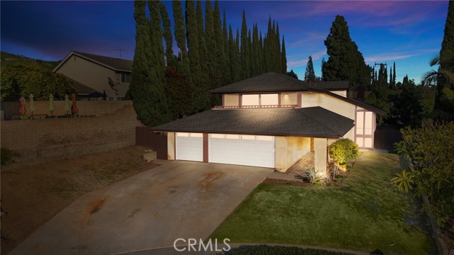 THIS HOME IS A MUST SEE! This beautiful home is located in the prestigious community of North Hills & Pleasant Hills area of Brea! It features 4 bedrooms and 3 bathrooms with 2,366 square feet of spacious living space on a 11,160 sq foot lot! Large living room at the entry with cathedral ceiling, lots of natural lighting, beautiful brick fireplace, beautiful view of the backyard and is adjacent to the formal dining room. The kitchen features plenty of cabinetry for storage, double ovens, gas cooktop, recessed lighting, counter seating and is open to the family room. The main floor also features a DOWNSTAIRS BEDROOM, BEAUTIFUL BATHROOM WITH SHOWER and Laundry Room. Upstairs showcases a LARGE Owners Suite that includes a beautiful bathroom with double sink vanity, private shower, TWO closets and your own private balcony. Two additional large secondary bedrooms and a beautiful full bathroom down the hall. The backyard is ready for your next BBQ! This private backyard features a HUGE yard with mature landscaping, fruit trees, concrete patio area. Take advantage of the Award-winning Brea Olinda Unified School District, Close to the Brea Mall, Downtown Brea, Restaurants. Come view this beautiful house and make it yours today!