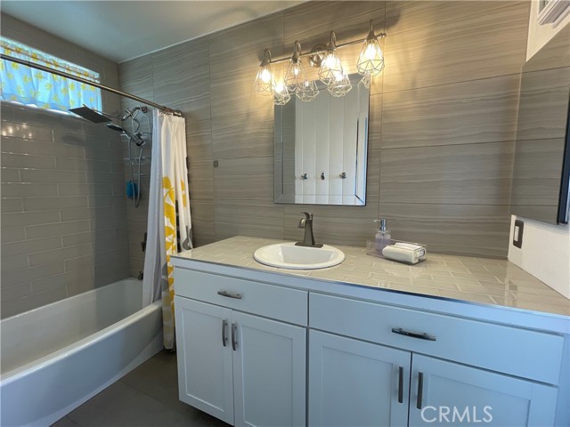 The main bathroom has class tile and updated vanity.