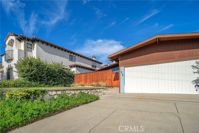 Steps to the front gate and enclosed patio with 2-car garage