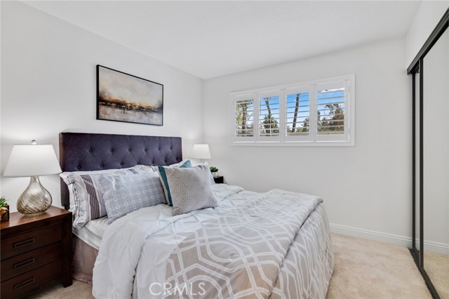 New mirror closet doors captures the relaxing ambiance of this bedroom upstairs.