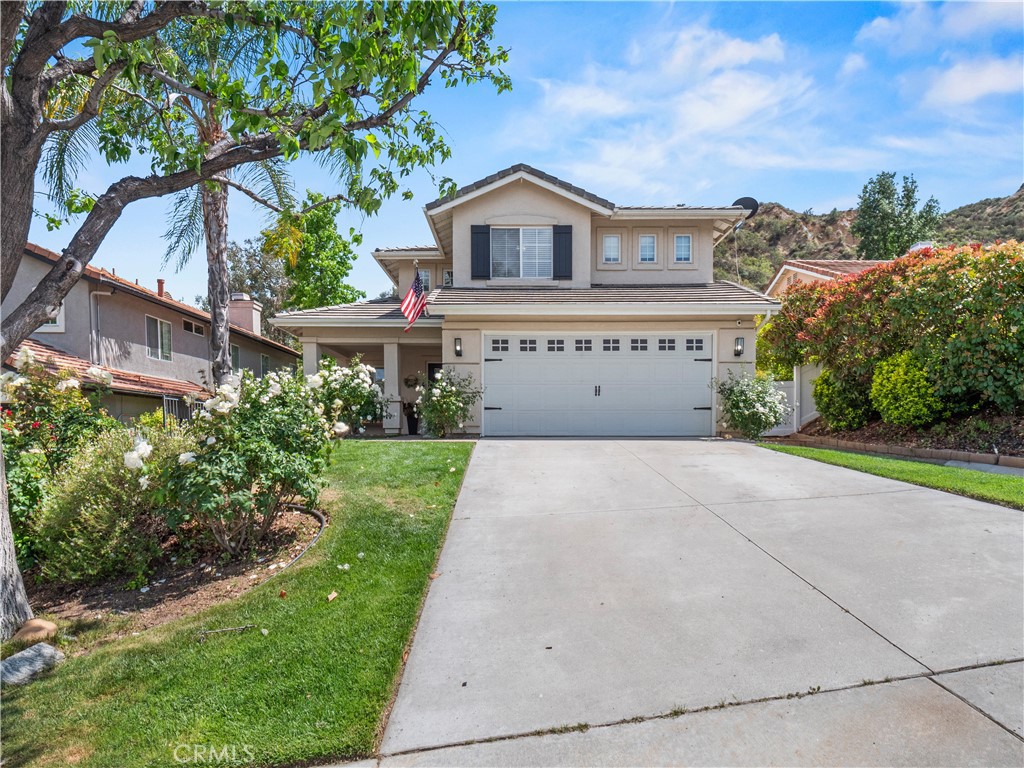 Beautifully updated home with mountain views and a private, serene setting! This light-filled property features new natural vinyl flooring, fresh carpet, and a modern, open layout. You're welcomed by soaring ceilings, large windows, and views of the lush backyard from nearly every room. The remodeled kitchen flows seamlessly into the living and dining areas—perfect for entertaining. Upstairs, the spacious primary suite offers stunning hillside views and a bright en-suite bath. Outside, enjoy an above-ground jacuzzi, mature landscaping with citrus and apple trees, a brand-new vinyl fence, and a detached studio ideal for a home office, gym, playroom, or creative space. Nestled against the hillside with no rear neighbors, this home is a true escape!