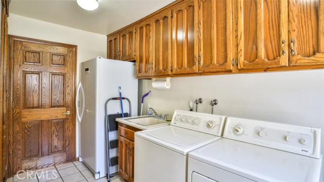 Spacious laundry room.  Notice the sink and abundance of cabinets