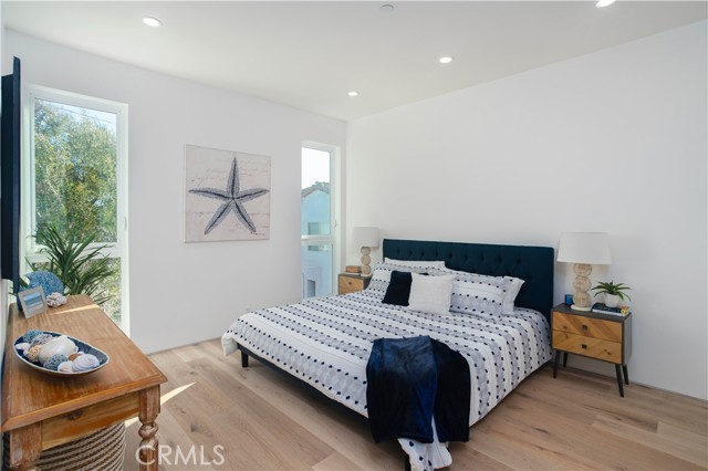 Primary bedroom with large windows (Unit A)