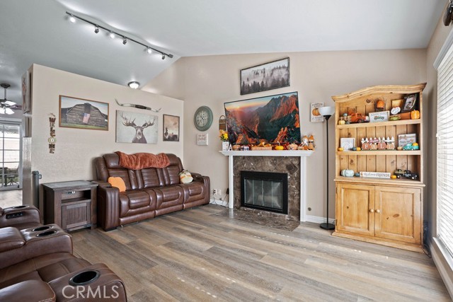 A Gas Fireplace welcomes you in this living room w/ abundant natural light and cathedral ceilings!