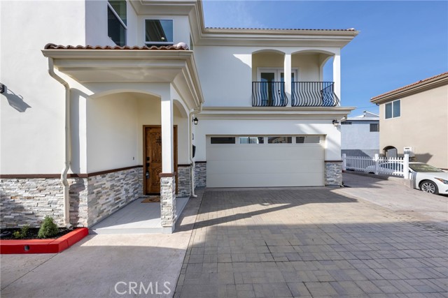 Primary bedroom has a balcony over 2 car garage.