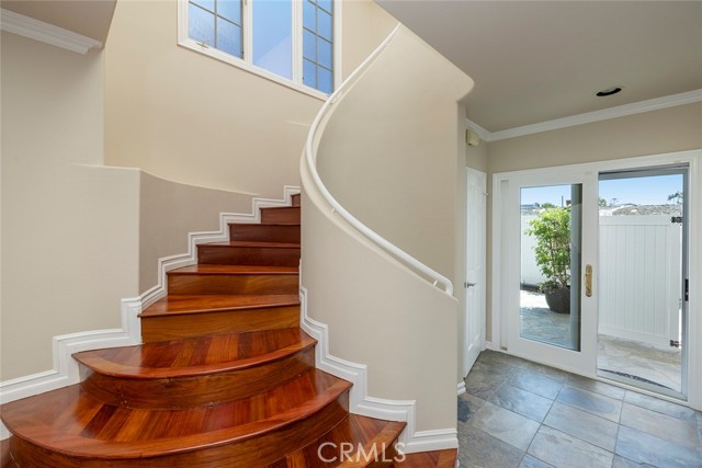 Beautiful spiral staircase with large closet space beneath and easy rear yard and alley access.