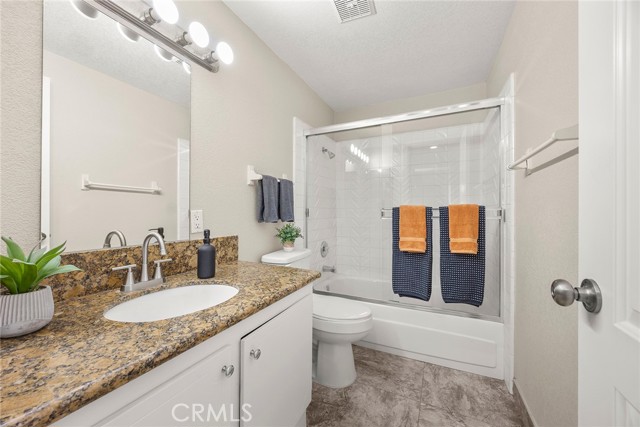 Hall bath is shared with 2 of the upstairs bedrooms. Full bath is complete with a single sink vanity. There is a shower over tub combination with glass enclosure.