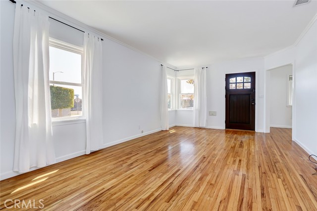 Oversized living room with gleaming hardwood floors.