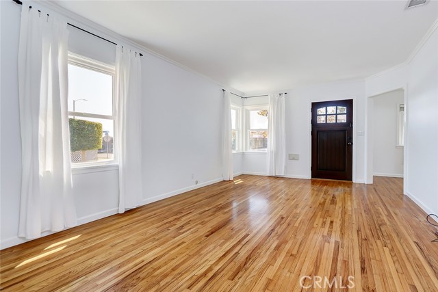 Oversized living room with gleaming hardwood floors.