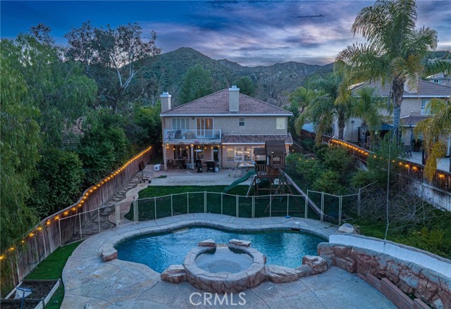 Stunning Castaic pool home with one of those yards you rarely find in Santa Clarita!  Located in the Double C Ranch neighborhood, this floorplan offers 3,071 sf of living space with just under a 10,000 sf lot.  The kitchen was completely remodeled in 2022 with quartz counters, new cabinets, high end Dacor stainless appliances, built-in refrigerator, large center island and a massive walk-in pantry.  Wood-like tile flooring throughout the downstairs, carpet just replaced throughout the upstairs, fresh interior paint. Large loft upstairs perfect for a second family room plus 4 additional bedrooms.  3rd car tandem garage has been enclosed and offers potential 5th bedroom/office.  Oversized primary bedroom with cozy fireplace, built in desk area, large walk-in closet with custom built-ins and private balcony overlooking the yard. The resort-like backyard is truly your own private oasis.  Covered patio, large grassy area with playset, built-in BBQ and a pool and spa with a waterslide.  Downstairs laundry room with sink and extra storage.  Amazing location just minutes from the freeway and a short drive to Castaic Lake.  No HOA, no mello Roos!!
