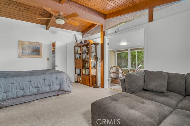 view  #3 of the second bedroom with a walk-in closet and easy access to the enclosed porch