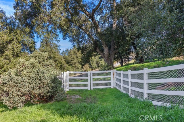 Lower gated area ideal for ADU, Barn, Hobby Garage with beautiful oak trees.