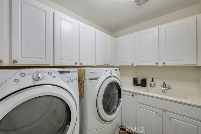 Laundry room, adjacent to the kitchen, on the way out to the garage.