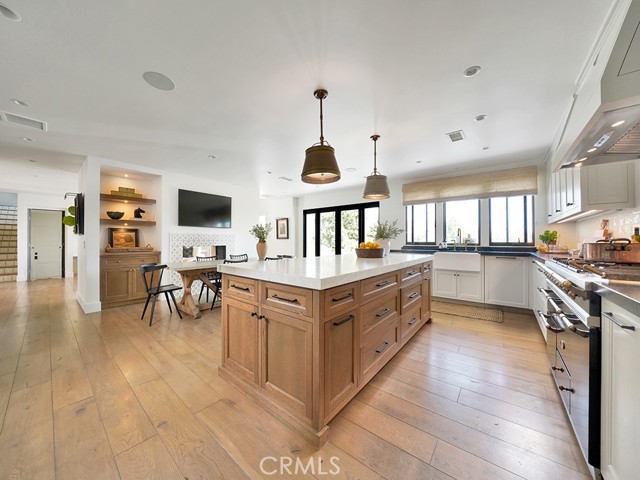  A timelessly designed true chef’s eat-in kitchen with butler’s pantry offers custom cabinetry with a custom paint color as well!