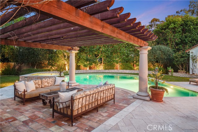 Arbor over the seating area next to the outdoor fireplace
