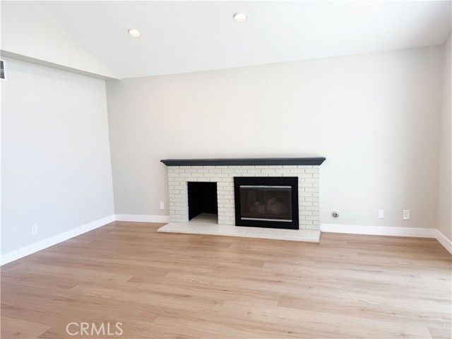 Living room with fire place and newly installed flooring