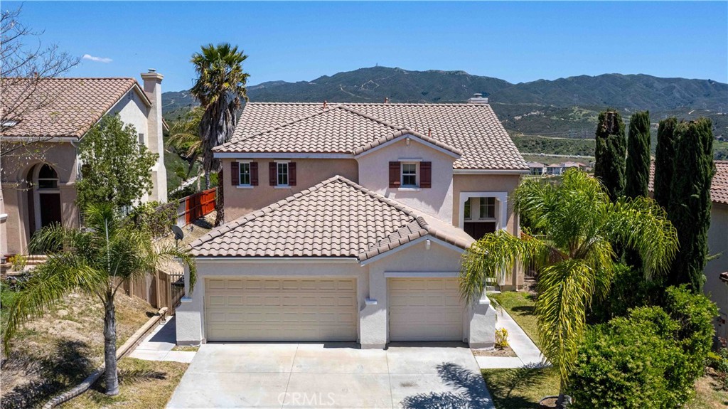 Welcome to your dream home in the heart of serene Newhall! This spacious 2,756 sq. ft. ranch-style residence offers the perfect blend of comfort, style, and functionality. Nestled in a quiet, sought-after neighborhood, this beautiful property boasts 4 generously sized bedrooms, including a luxurious master suite designed for relaxation with a private bath and ample closet space.Step into the inviting high-ceiling living room, where natural light pours in, creating a bright and airy ambiance—ideal for both everyday living and entertaining. The home features 3 well-appointed bathrooms,  plenty of room for the whole family. You'll love the great-sized closets throughout the home, offering plenty of storage, and the 3-car garage provides both convenience and extra space for vehicles, hobbies, or a workshop. Built in 2000, this home has been well-maintained and offers breathtaking views of the surrounding landscape—a perfect backdrop for morning coffee or evening unwinding. Whether you're looking for a family home or a peaceful retreat, this property delivers the ideal combination of space, location, and charm.