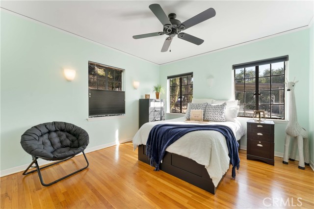 Large bedroom #2 with a walk-in closet, ceiling fan and lots of windows.