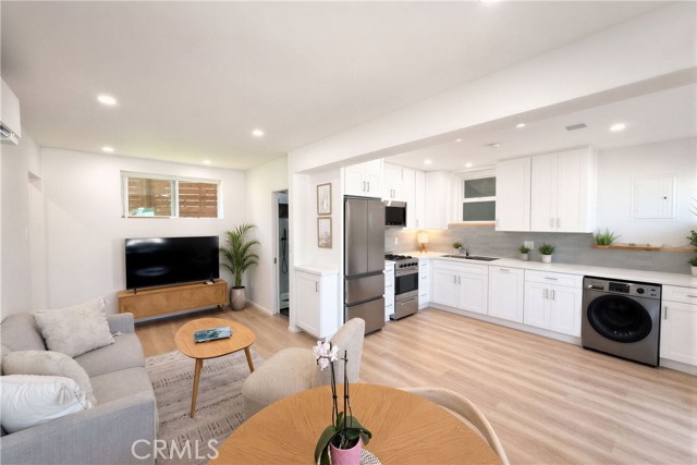 Turn-key lower unit offers a bright and beautiful layout with wide plank flooring, updated kitchen, recessed lights and an open concept design