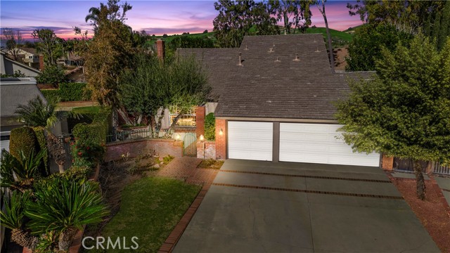 This beautiful four-bedroom home sits on a cul de sac located in the sought after North Hills community of Brea. The property boasts four-bedrooms, a three-car garage, and an extremely desirable floor plan with a main floor bedroom. As you enter through the double doors you will notice the wonderful airy feel that the high vaulted ceilings and newly replaced double paned windows give the home. The formal dining room is adjacent to a formal living room that features a lovely fireplace and mantle. In the lovely kitchen you will find plenty of cabinets, recessed lighting and granite countertops. The family room has lots of windows looking out to the very serene lush private backyard. Upstairs you will be amazed how large the two secondary bedrooms are. The primary bedroom has an all-new primary bathroom with beautiful new double sinks, granite countertops, custom vanities and an extra-large walk-in shower with custom tile that is one of a kind. The backyard offers so much for those nature lovers with all its trees and lush plants. You will love all the amenities the North Hills Community has to offer including an Olympic size swimming pool, a large club house, tennis courts and more. The home is centrally located near the 57 fwy, downtown Birch Street and the Brea mall. Don’t forget about Brea’s award-winning school district! Don’t miss this one!!