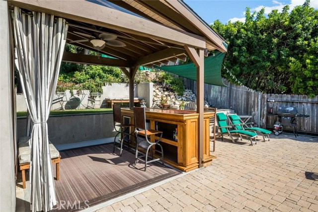 Beautiful oak wood bar complete with covered patio and guest house - excellent entertaining area with stone pavers and a large grassy yard.