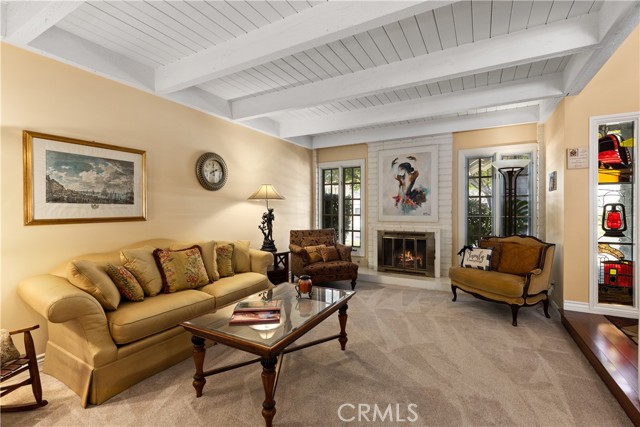 Formal living room with fireplace, new carpeting, and new paint.