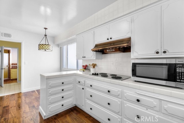 The kitchen has plenty of counter space, and double ovens.