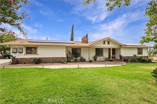Front of home features a large front yard with a water fountain.
