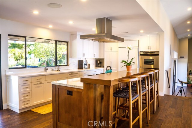 Kitchen has view to backyard and front with ocean