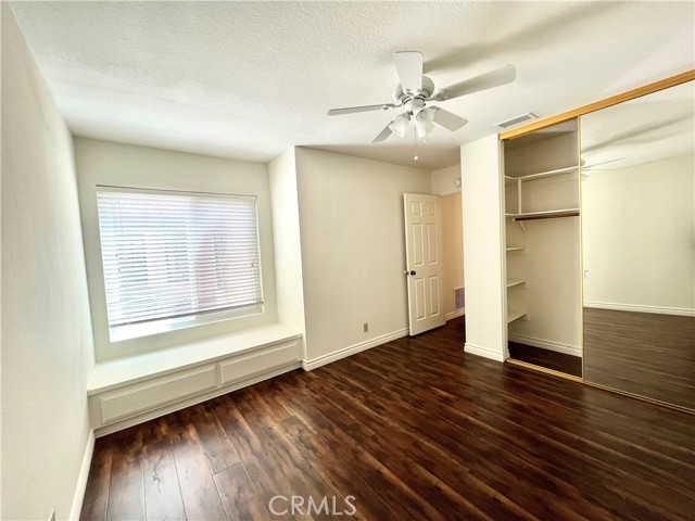 Bedroom with window seat and storage drawers