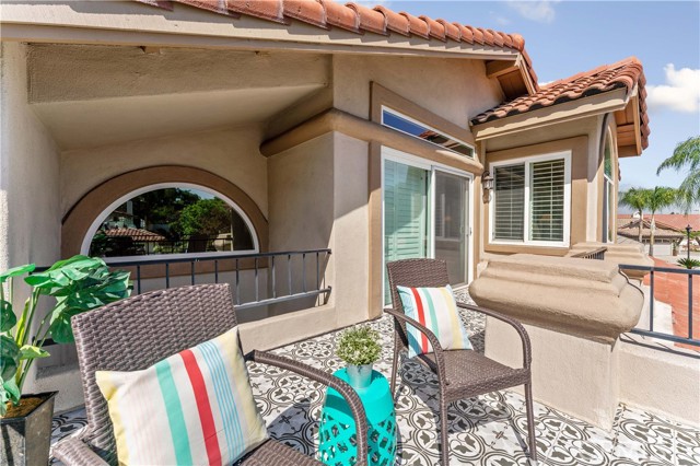 Just the right amount of space to set some chairs and a table and enjoy the view from the primary suite of the neighborhood and trees. Notice the custom chosen tile adding charm.