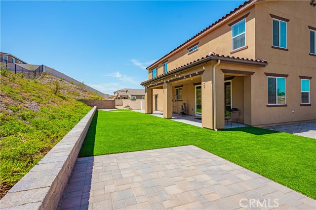 Astro turf back yard with outdoor back yard patio. Pocket sliding glass doors open to the patio. Brick pavers were just installed as well.