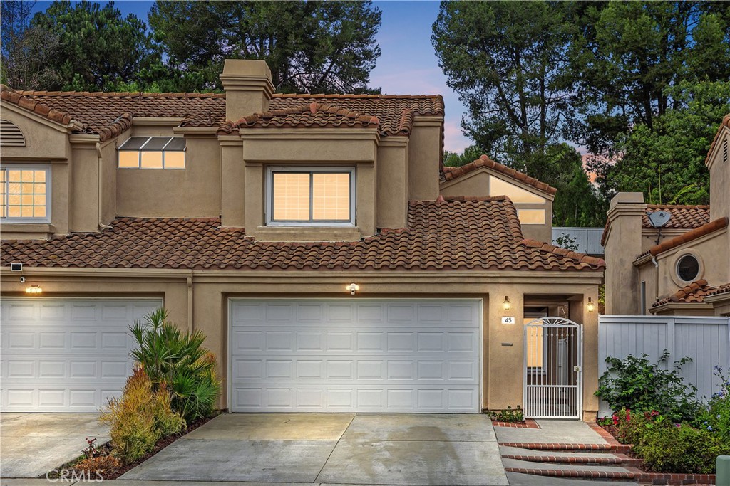 Welcome home to 45 Dunn Street located in the highly sought after Saltaire Community of Laguna Heights. Situated on a quiet culdesac street, this beautiful residence offers 2 bedrooms, 2.5 baths and 1,440 sq ft of comfortable living space.  The gated courtyard entry welcomes you inside.  Upon entry you are greeted by the high ceilings and open floorplan.  The spacious living room offers a gas fireplace, tall windows and a french door leading out to the backyard patio for indoor and outdoor living.  The bright sunny kitchen offers white wood cabinetry, upgraded counter tops, under cabinet lighting, garden window, and a breakfast nook.  The spacious dining room features a mirrored wall and opens to both the kitchen and living room.  Features include upgraded laminate wood flooring, custom window shutters, vaulted ceilings, light neutral paint, recessed lighting, and ceiling fans throughout the home.  Downstairs offers a laundry room and a powder room.  Upstairs is the spacious primary suite with high ceilings and large windows overlooking the backyard, large walk-in closet, remodeled bath with custom tiles, clear glass shower enclosure and built in cabinets. Down the hallway is the secondary bedroom with a large closet, window seat, and a remodeled bathroom with tiled shower. The beautiful backyard features a covered patio with dining area, large grass yard and stepping stones leading to the beautifully landscaped terraced slope with fruit trees and room to plant your vegetable garden if desired.  Enjoy relaxing and entertaining in this peaceful and private backyard.  The two-car garage includes epoxy flooring and storage.  This home is a short distance to Chapparosa Community Park with basketball courts, baseball and soccer fields, sand volleyball, playground picnic area and walking trails.  Nestled in a coastal location, you’ll enjoy the convenience of a short drive to the beach, Capistrano schools, shops, restaurants, and freeways. Low HOA and no mello roos tax.  Don’t miss the opportunity to make this delightful residence your own.