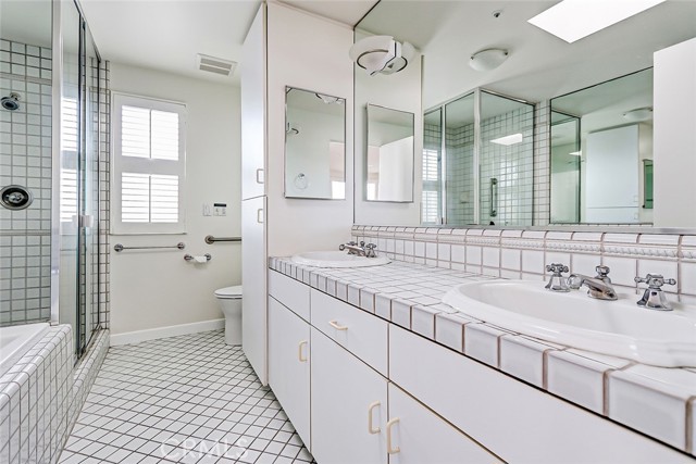 Primary suite bathroom with dual sinks.