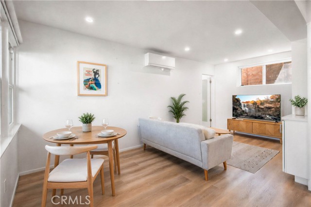 Lower unit with recessed lights, wide plank flooring, great light, open concept floorplan, mini-split heating and air