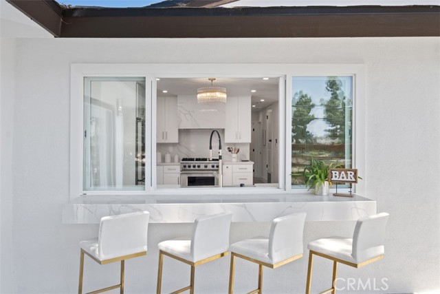 Outdoor breakfast bar with bar seating.