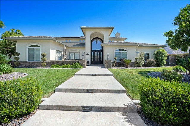 One of The Largest Spectacular Custom View Style Estates offered. This Crown Jewel is artfully designed for sumptuous private living on a one of a kind tree lined cut de sac street. Sitting on approximately a 43000 square foot lot of prime Yucaipa Real Estate. Quality craftsmanship throughout is outstanding and delivers perfection at every level. Private courtyard with an amazing sitting area is perfect for morning coffee. Open and lengthy floor plan comes with a true professional gourmet kitchen fully upgraded with gorgeous quartz countertops, luxurious cabinetry, recessed lighting, breakfast nook and includes top of the line Kitchen-aid 6 burner cooktop, built-in refrigerator, main sink and separate prep-sink Stainless galore! Large family room with grand fireplace, separate game room hosts a pool table and balcony. Primary suite is a luxurious private refuge with warm fireplace. Primary bath boasts large shower, separate tub and walk-in closet. Every bedroom is well-sized and close to their en suite private bathrooms. Rear yard has a separate BBQ area, amazing pebble sheen pool and spa with an absolutely breathtaking view of the valley and mountains. Additional four car oversized garage accommodates all your toys! RV parking perfect for your boat, RV or toy hauler. All custom paint, flooring, tile, window coverings, and blinds have been professionally done in neutral colors to easily match any decor. Just way too much to mention in this custom built home. See the photos, they say it all.