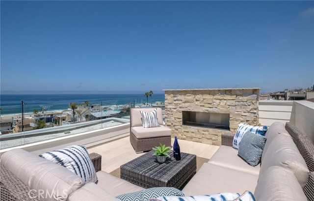 Rooftop Deck with Big Fireplace, sit down views and wind protection from glass railing