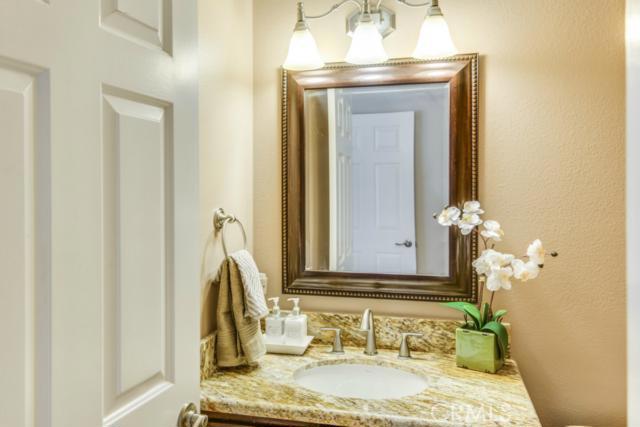 Updated half bath located on mid level. Really nice fixtures and granite counter top.