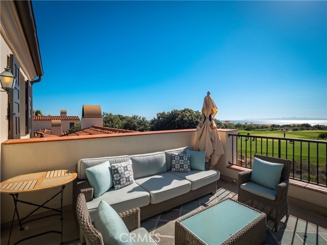 Private balcony with golf course and ocean views.