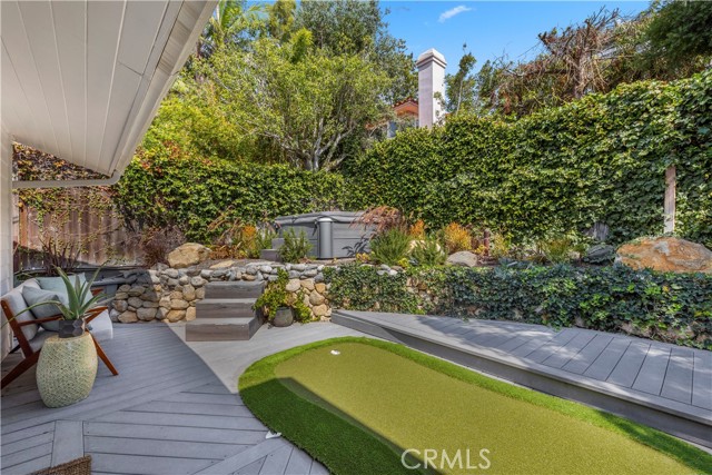 Backyard with putting green and hot tub