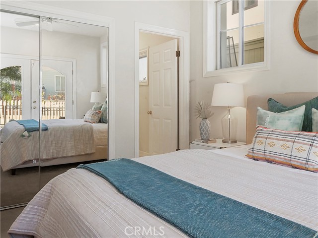 bedroom 3 with private bath and private french doors overlooking grassy yard