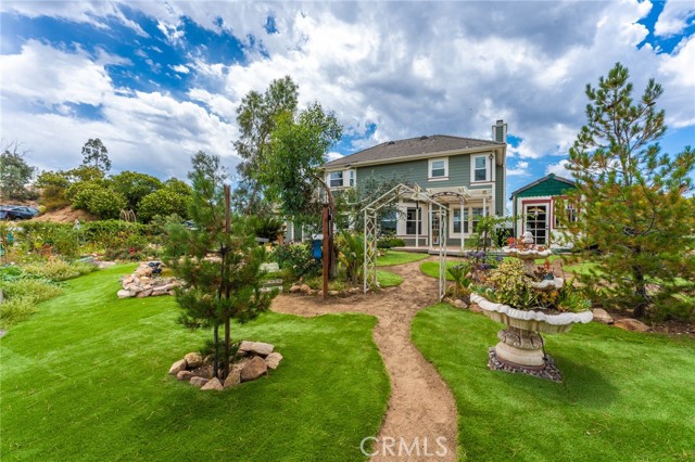 Looking south toward the home from the fully fenced backyard.