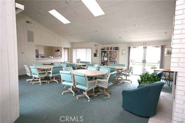 Inside the clubhouse is a full functioning kitchen and several table & chair options, as well as a gas fireplace. Vaulted ceiling and skylights drench the area with lots of natural light.
