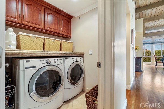 Interior laundry room with folding area and storage