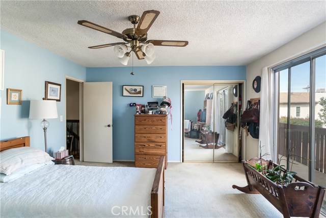 Large bedroom 2 with mirrored closet and private balcony.