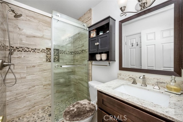 Stunning tile work and glass shower door complete the design.