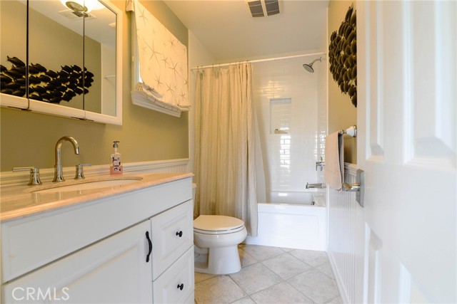 Full bath on the lower level with wainscoting throughout